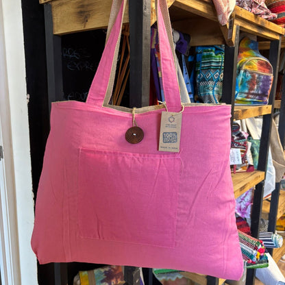 Alt Tag: Eco-Chic Reversible Jute & Cotton Bag – Pink, pink reversible jute and cotton tote bag with shoulder straps, front pocket and tag