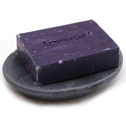 Alt Tag: Elegant Grey Soapstone Dish – 10x12CM Oval, handcrafted oval grey soapstone dish holding a purple bar soap