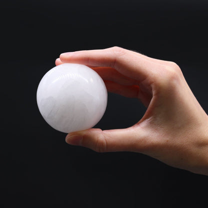Enchanting Selenite Sphere – 5 to 6 CM held in hand, polished white selenite crystal sphere on black background