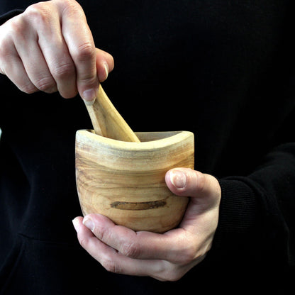 Alt Tag: Ergo Teak Pestle & Mortar – Small teak wood mortar and pestle held in hands for grinding herbs and spices