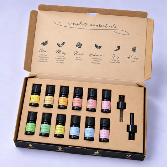 Open essential oil starter set with amber bottles in their organiser and two glass droppers against a pale background.