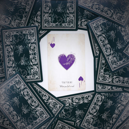 Alt Tag: Fae Realm Oracle Cards – 54-Card Deck spread with ornate black backs and central heart card, fairy-themed premium oracle deck