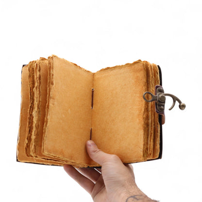 Alt Tag: Fat Deckled Leather Notebook – 15.5x10 CM open handmade leather journal with deckled pages and metal clasp, held in hand