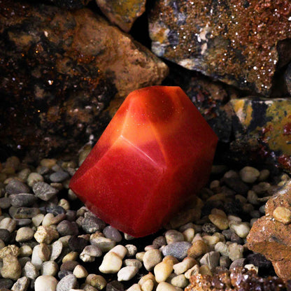 Alt Tag: Fiery Crystal Soap – 6.2x6.2x6.5 CM red crystal-shaped soap bar displayed on pebbles and rocks