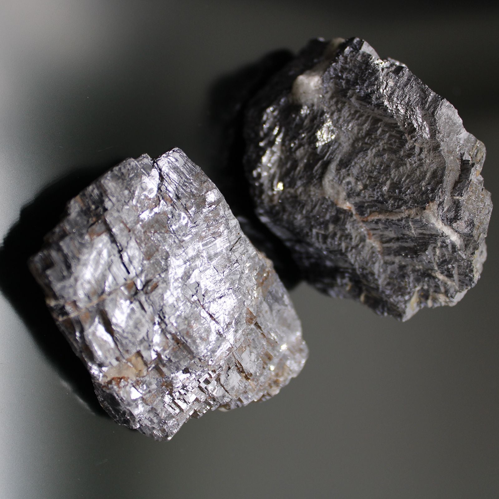 Galena Rare Mineral Specimens – Approx 80 Pieces, close-up of two silver-gray galena crystal mineral rocks on dark background
