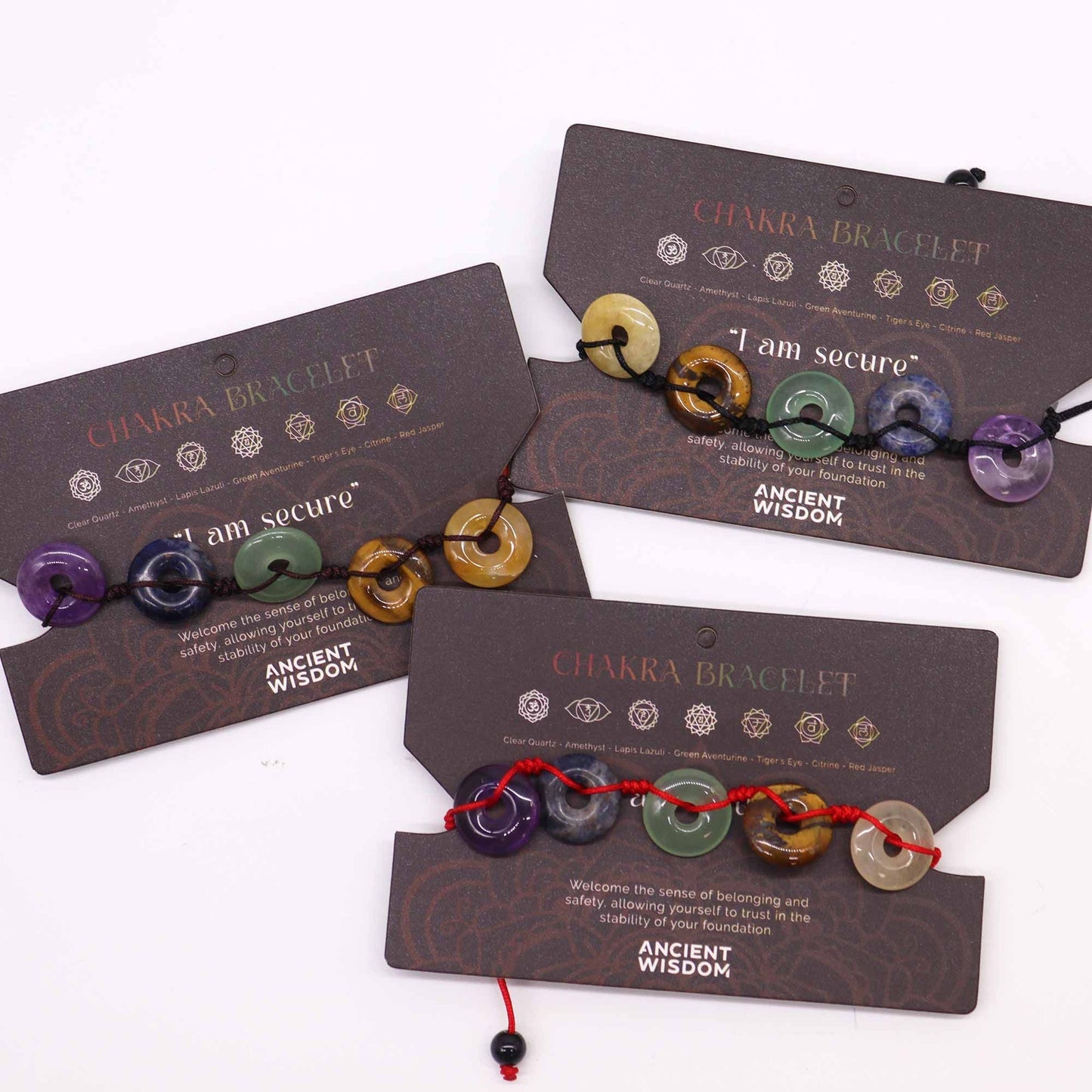 Gemstone Chakra Bracelet – Large Donuts on display cards with multicolor gemstone donut beads and adjustable cord