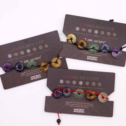 Gemstone Chakra Bracelet – Large Donuts on display cards with multicolor gemstone donut beads and adjustable cord