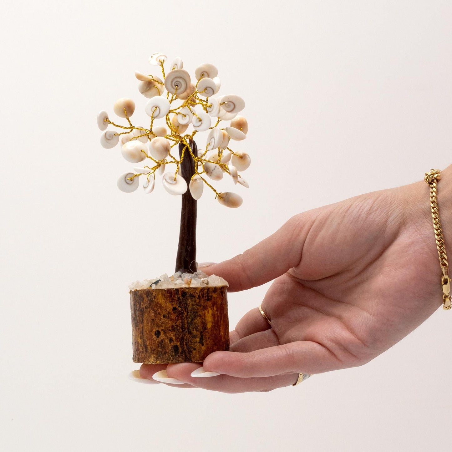 Alt Tag: Gemstone Gomati Chakra Stone Tree – Medium (45 Stones) in hand, white stones on gold wire branches, wooden base
