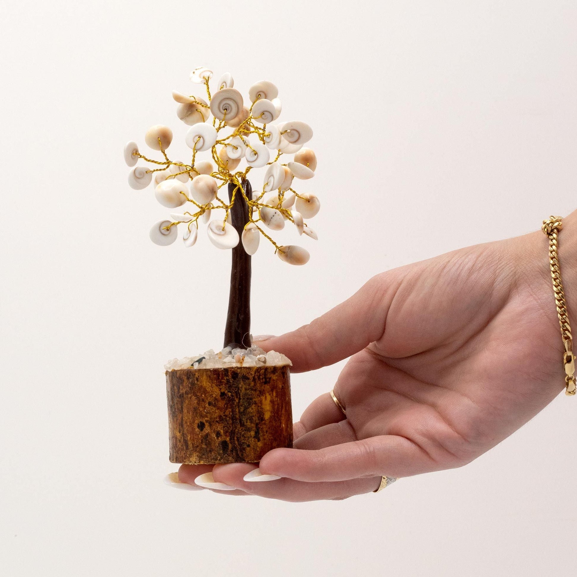 Alt Tag: Gemstone Gomati Chakra Stone Tree – Medium (45 Stones) in hand, white stones on gold wire branches, wooden base