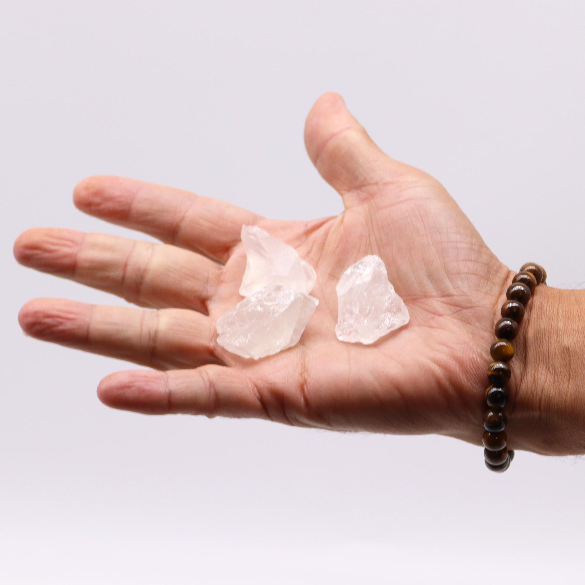Alt Tag: Gemstone Raw Crystals – Rock Quartz 500G raw rock quartz crystals held in hand, natural clear stones close-up