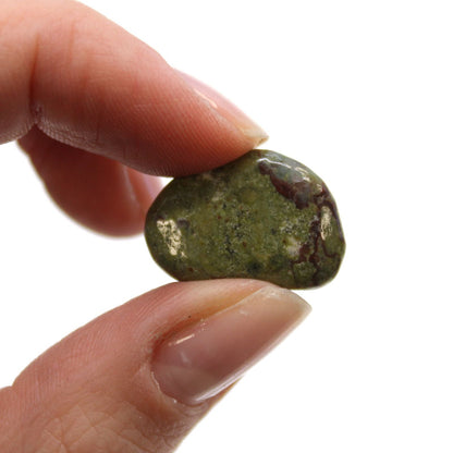Alt Tag: Gemstone Tumble Stones Bag – 24 Dragon Pieces, close-up of green African tumbled gemstone stone held between fingers