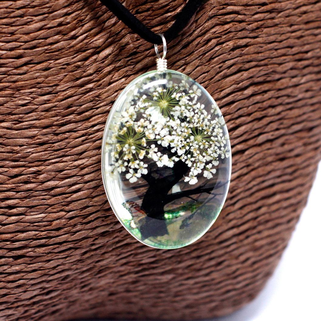 Alt Tag: Glass Pressed Flowers Jewelry – Tree of Life (White) oval glass pendant with real white pressed flowers on black cord