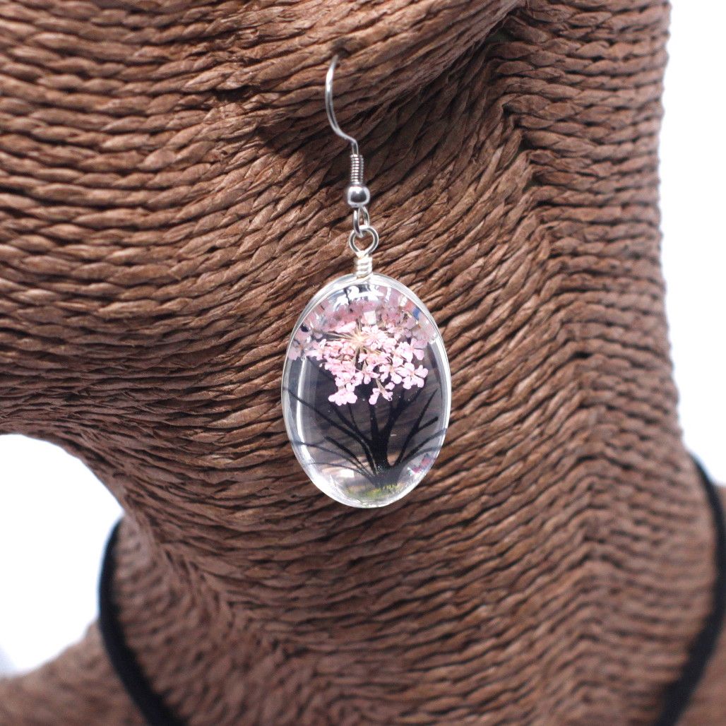 Glass & Flowers Jewelry – Tree of Life, Pink earring with pressed pink flowers encased in oval glass pendant, hanging on display bust