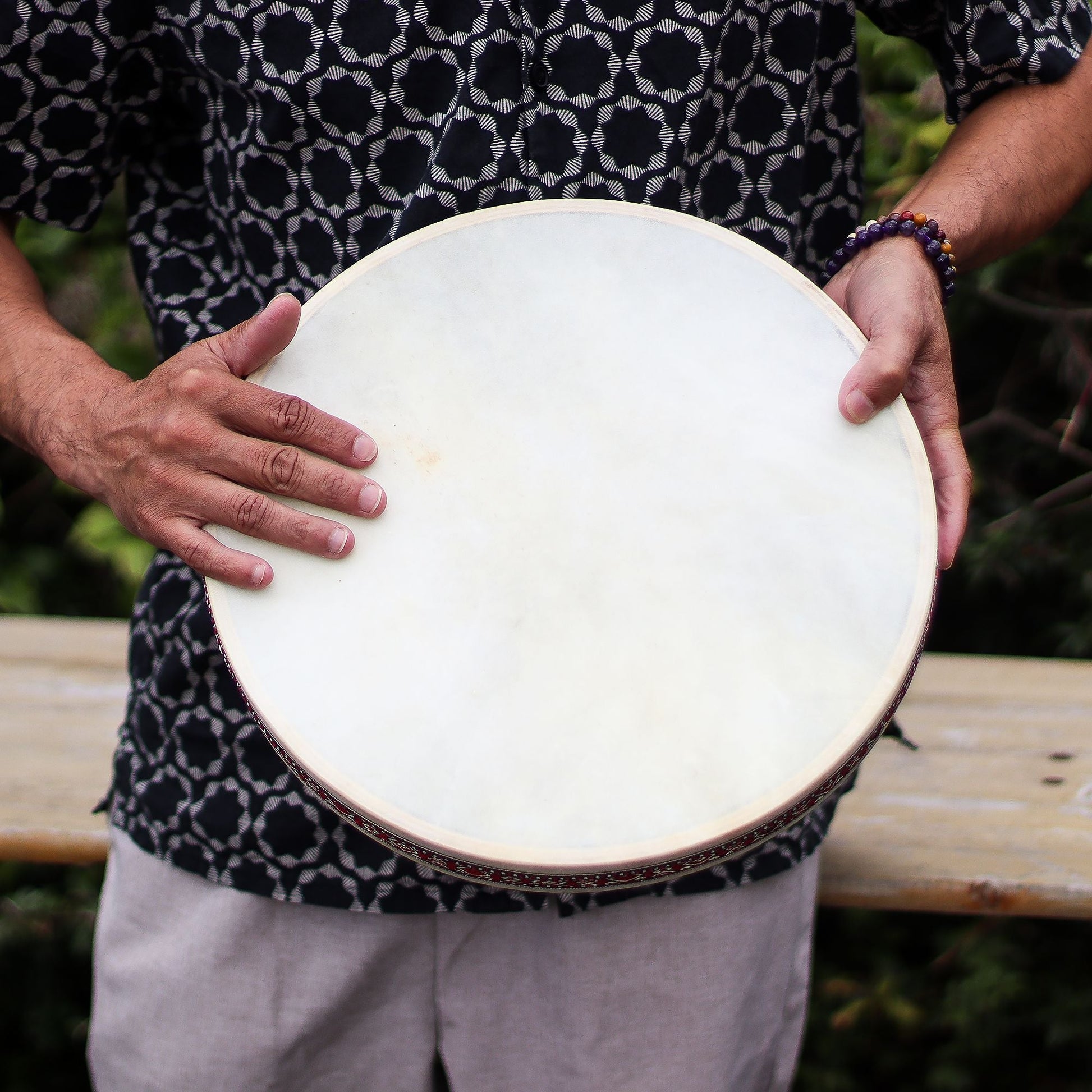 Goatskin Shamanic Ocean Drum – 35CM held by person outdoors, close-up of natural goatskin drumhead