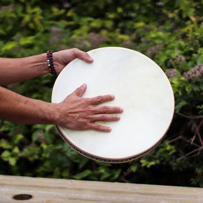 Alt Tag: Goatskin Shamanic Ocean Drum – 35CM held by hands, round frame drum with natural goatskin head outdoors