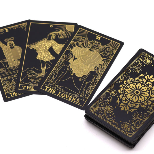 Alt Tag: Gold Foil Tarot Set – Gift Box with Book, black tarot cards with metallic gold foil illustrations and ornate card back design