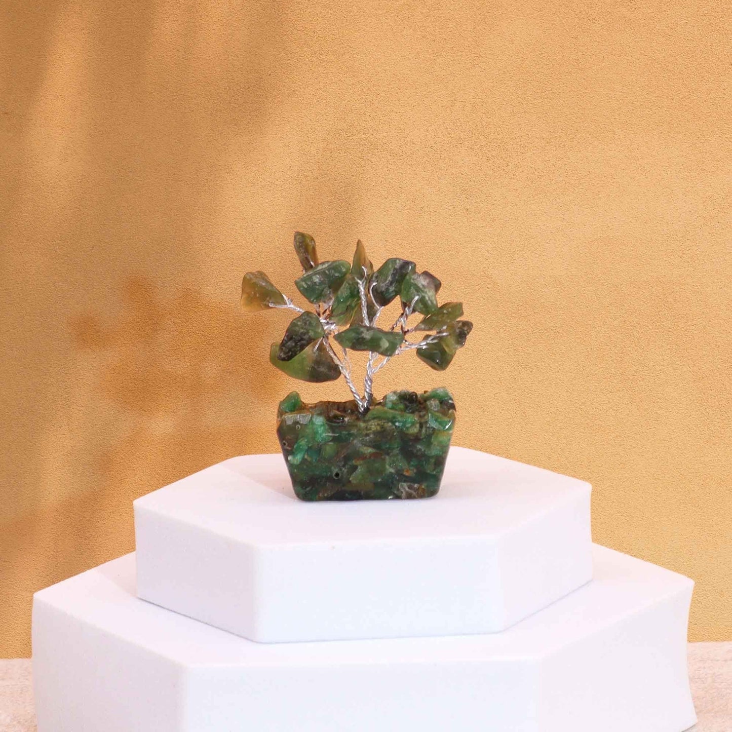 Alt Tag: Green Aventurine Mini Gemstone Tree – 15 Stones with orgonite base on white pedestal, green gemstone leaves decor