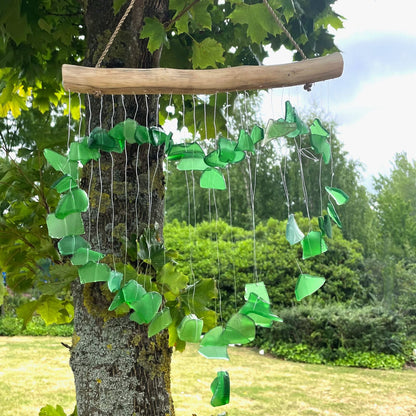 Alt Tag: Green Recycled Glass Wind Chimes – 30x60 CM hanging on tree, handmade recycled green glass pieces with driftwood hanger outdoors