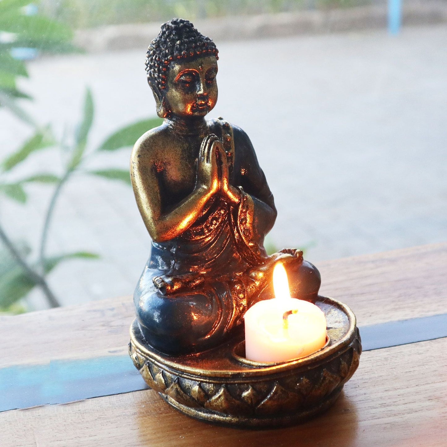 Alt Tag: Hand Painted Buddha Candle Holder – Red Medium resin Buddha statue with tealight candle, hand-painted Balinese decor on wooden table
