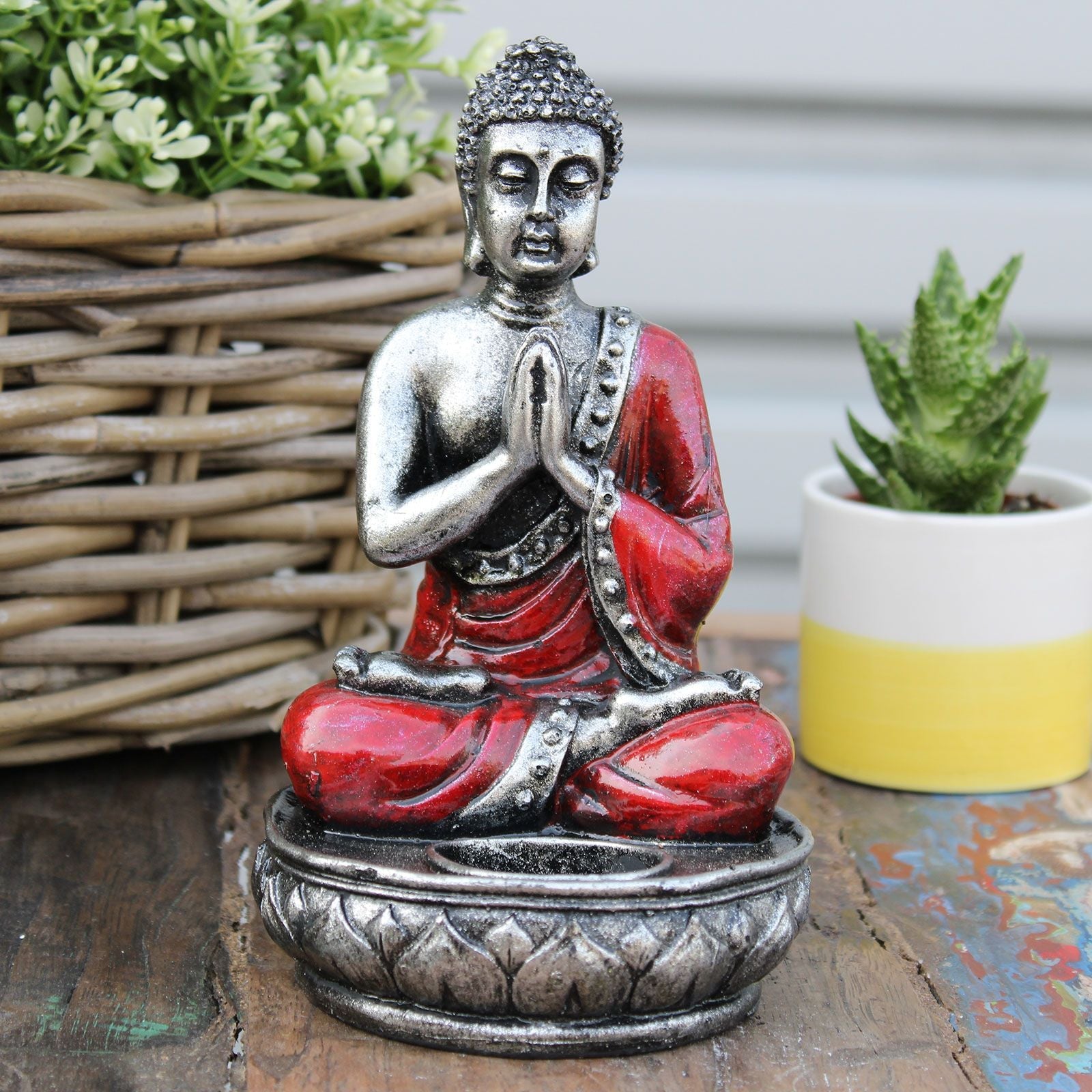Alt Tag: Hand Painted Buddha Candle Holder – Red Medium resin Buddha figurine in red and silver, seated meditation design on tabletop