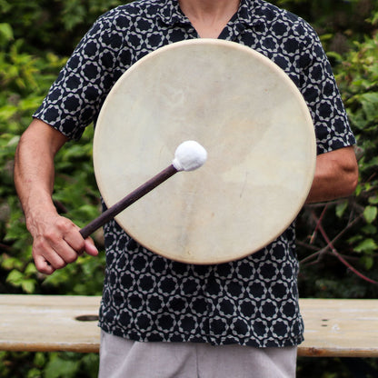 Alt Tag: Handcrafted Acacia Shaman Drum – 40 CM held by person with mallet, natural leather drumhead and acacia wood frame