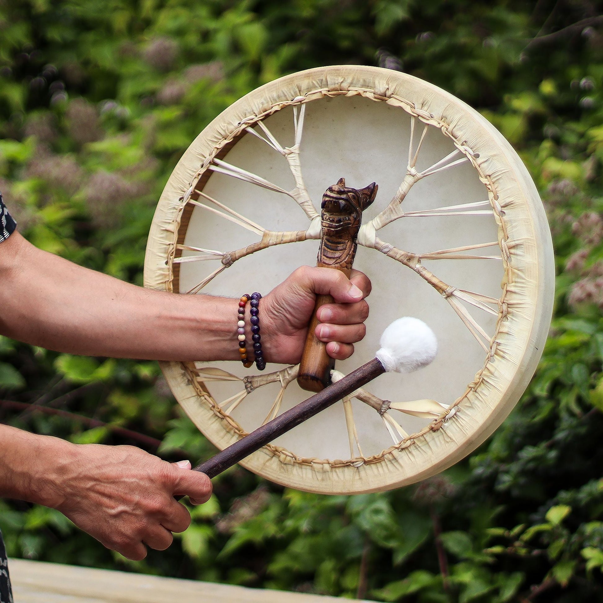 Alt Tag: Handcrafted Acacia Shaman Drum – 40 CM held outdoors, leather frame drum with wooden handle and soft mallet in hand