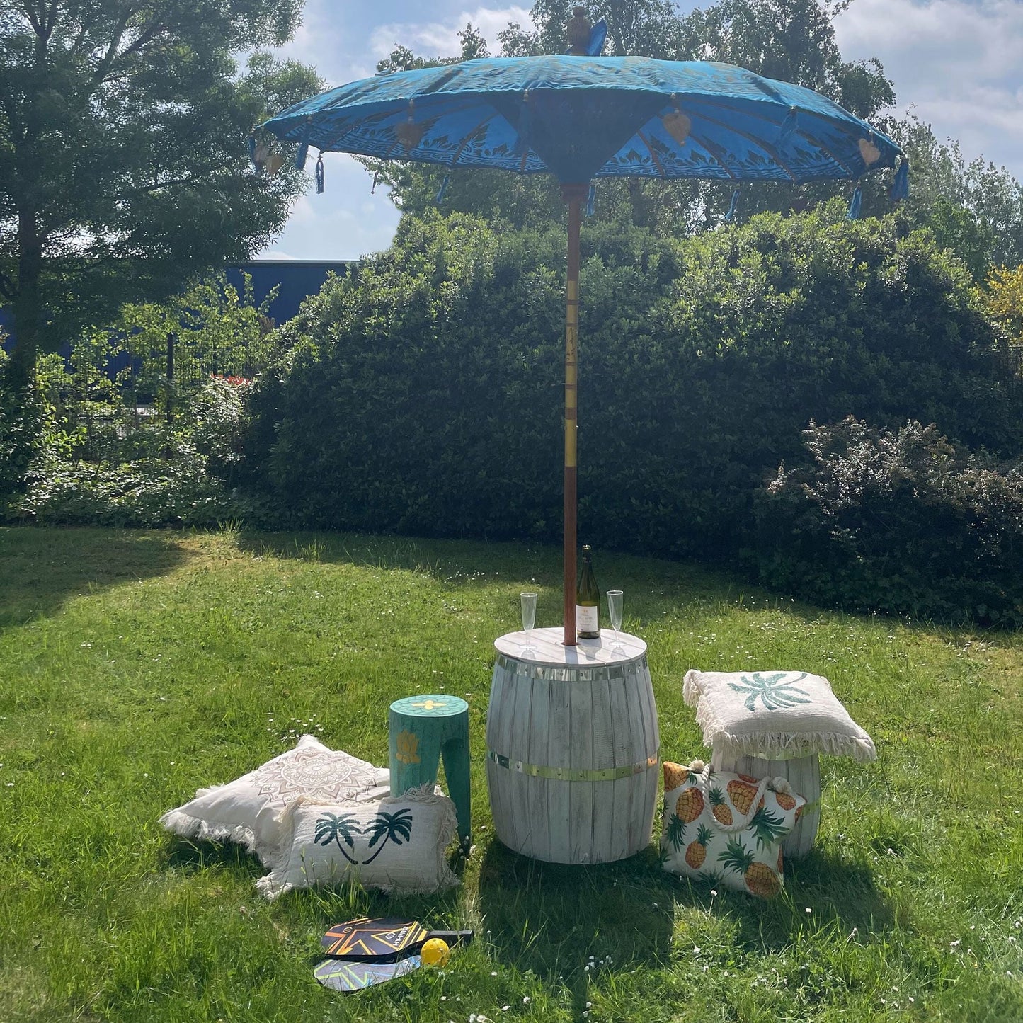 Alt Tag: Handcrafted Cotton Bali Parasol – Turquoise 200CM outdoor patio umbrella in garden setting with wooden pole and decor cushions