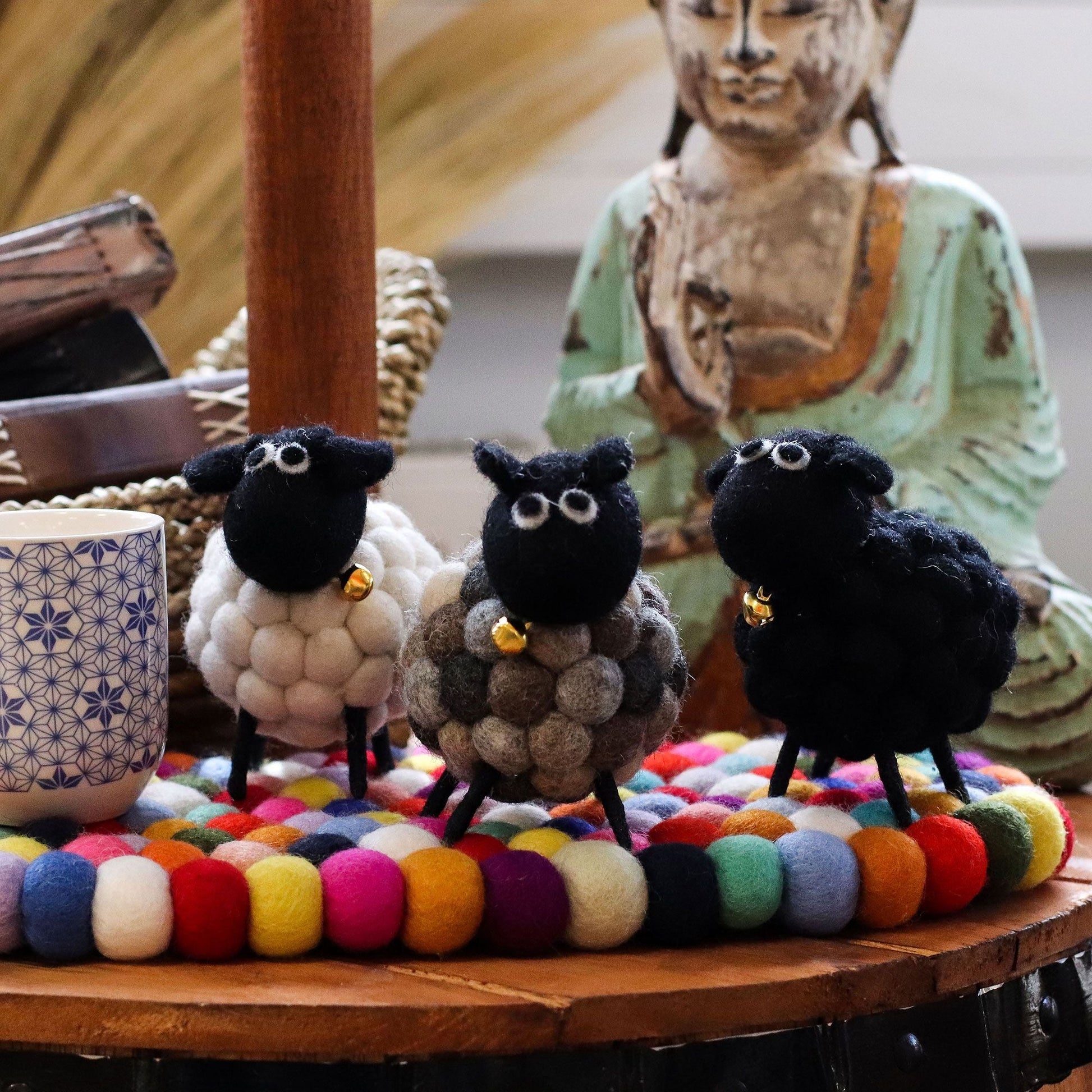 Handcrafted Felt Sheep – Black 12x8x10 CM black felt sheep decor on colorful felt ball mat with rustic statue backdrop