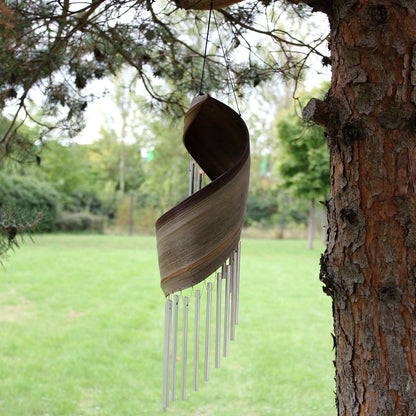 Handmade Coconut Leaf Wind Chimes – 50x13 CM hanging on a tree branch outdoors, coconut leaf wrap with metal chime tubes