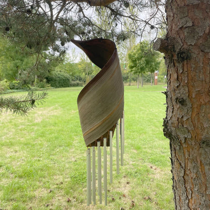 Alt Tag: Handmade Coconut Leaf Wind Chimes – 50x13 CM hanging outdoors with coconut leaf top and metal tubes on a tree
