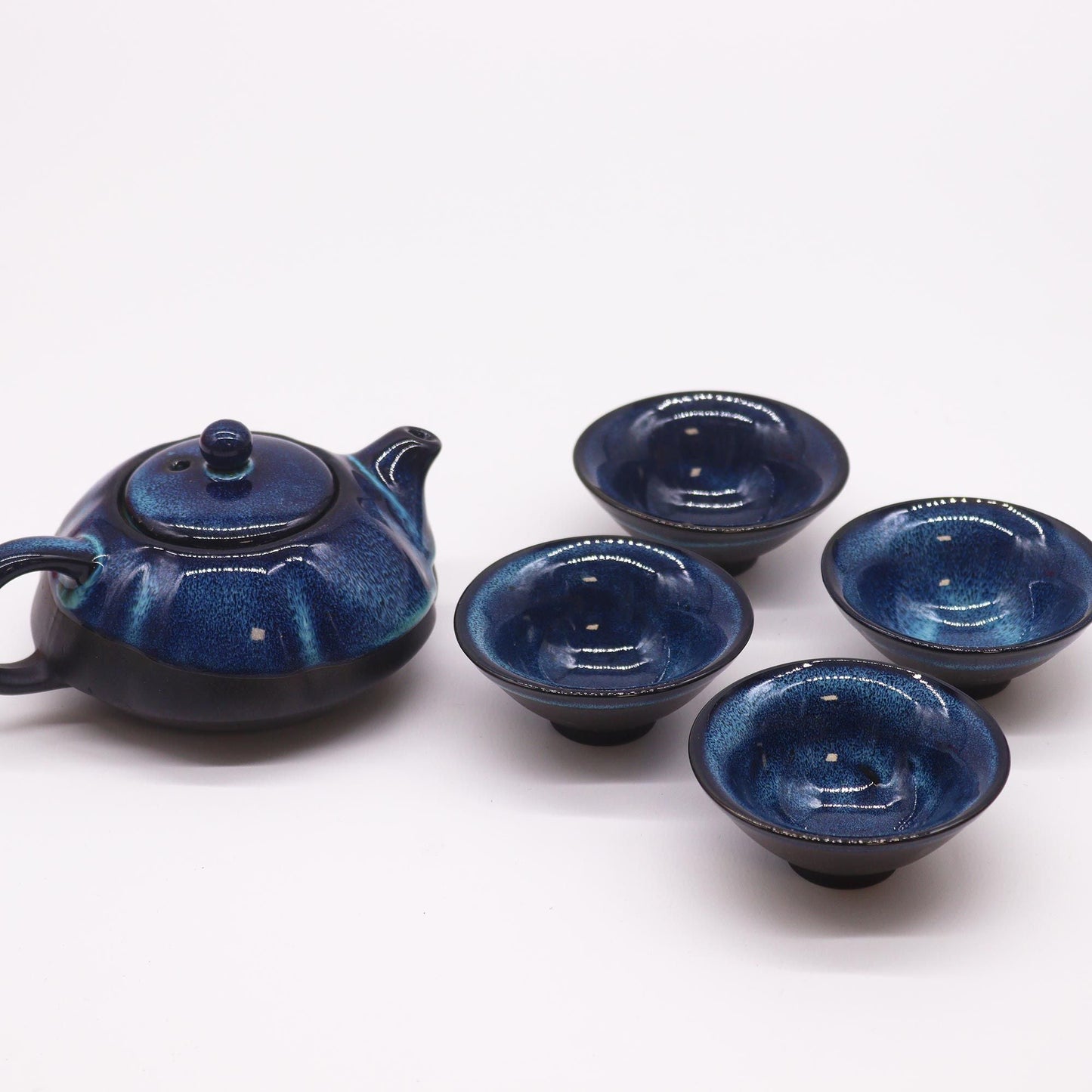 Alt Tag: Herbal Blues Teapot Set – Pot & Four Cups handcrafted blue ceramic teapot with lid and four matching cups, ocean-wave glaze