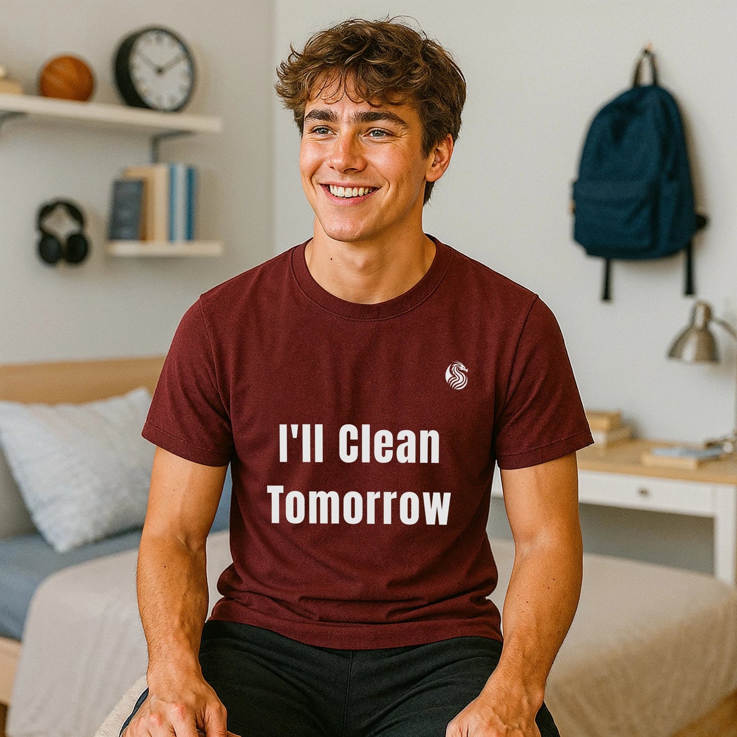 Alt Tag: I'll Clean Tomorrow Teen Premium Unisex T-Shirt en color burdeos con texto “I’ll Clean Tomorrow”, modelo sentado en dormitorio