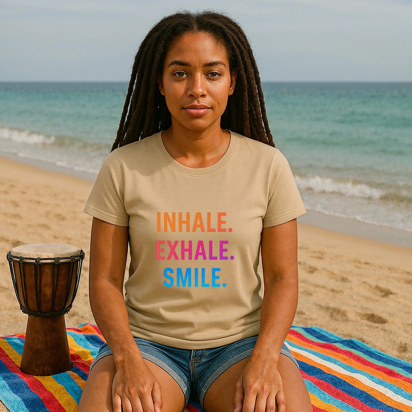 Alt Tag: Inhale Exhale Smile Mindfulness 100% Organic Cotton T-Shirt worn by woman on beach, beige tee with Inhale Exhale Smile print