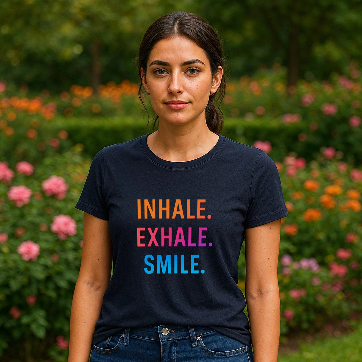 Alt Tag: Inhale Exhale Smile Mindfulness 100% Organic Cotton T-Shirt on model, navy tee with “INHALE EXHALE SMILE” text in garden