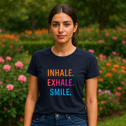 Alt Tag: Inhale Exhale Smile Mindfulness 100% Organic Cotton T-Shirt on model, navy tee with “INHALE EXHALE SMILE” text in garden