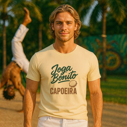 Joga Bonito Capoeria Sustainable Unisex Tee on model, cream capoeira graphic t-shirt with Joga Bonito Capoeira print outdoors
