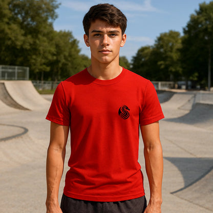 Alt Tag: Joven Dragon Premium Unisex T-Shirt roja con logo negro, modelo unisex en skatepark al aire libre
