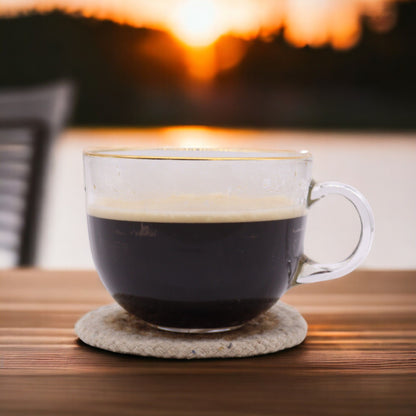 Glasunderlägg i jute & bomull – 10CM set med 4 som håller en kaffekopp i glas på ett rustikt bord, naturligt jute- och bomullsunderlägg med elfenbensfärgad kant