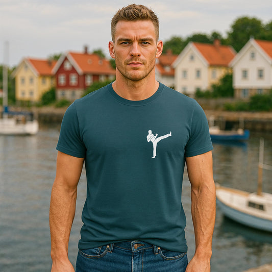 Alt Tag: Hombre con camiseta azul con gráfico de patada de karate, Karate Kick Sustainable Unisex Tee, vista frontal al aire libre junto al agua