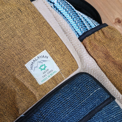 Alt Tag: Large Boxy Hemp Backpack – Teal & Turmeric close-up of hemp and cotton fabric, teal and turmeric panels, zipper pocket and label