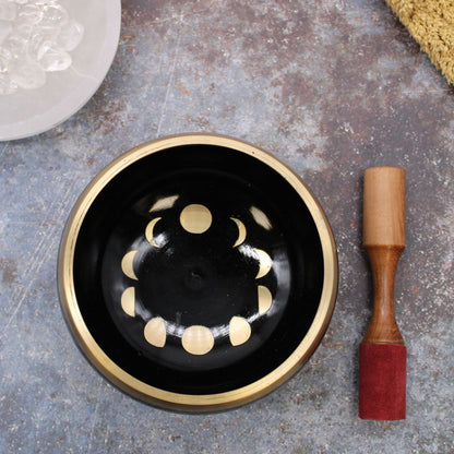 Alt Tag: Large Moon Phase Singing Bowl Set – Black – 14 CM matte black 14 cm singing bowl with gold moon phase design and wooden mallet