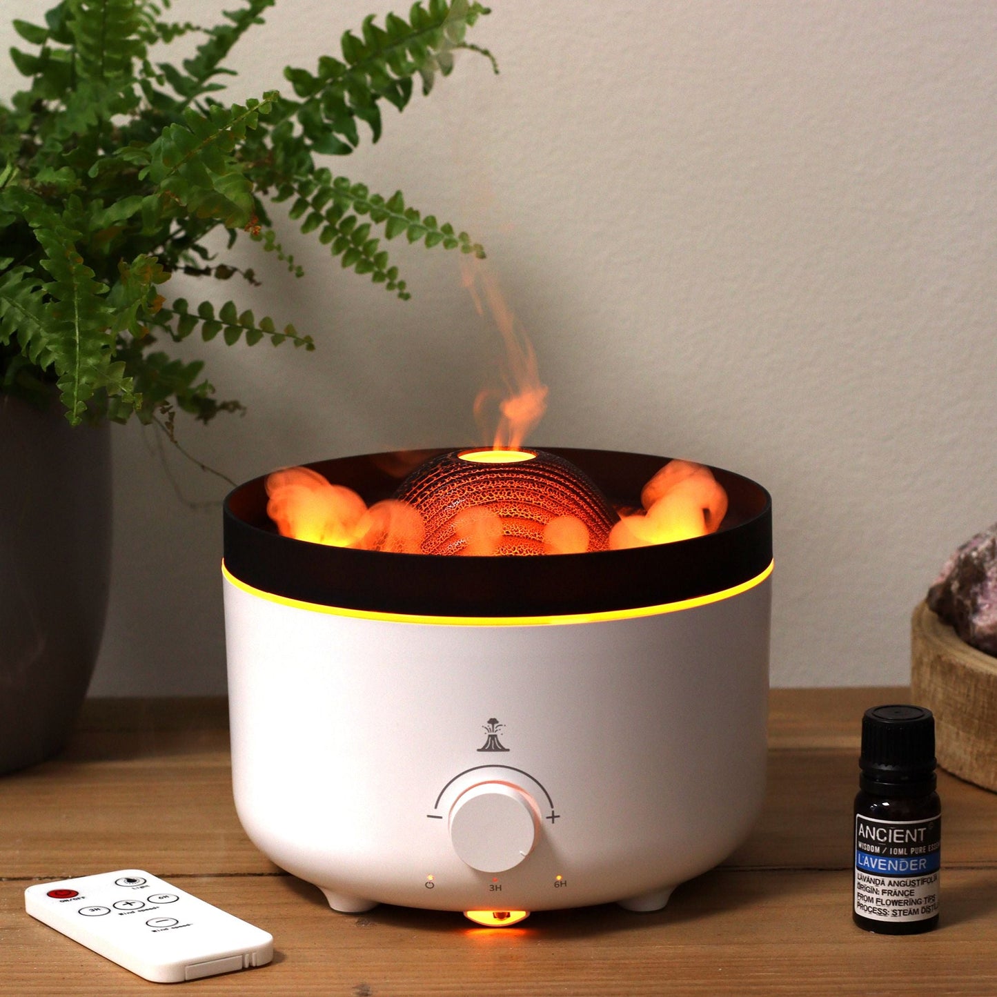 Large Volcano Effect Aroma Diffuser (Plug) – Two Colours with volcano-style mist effect on table next to essential oil bottle