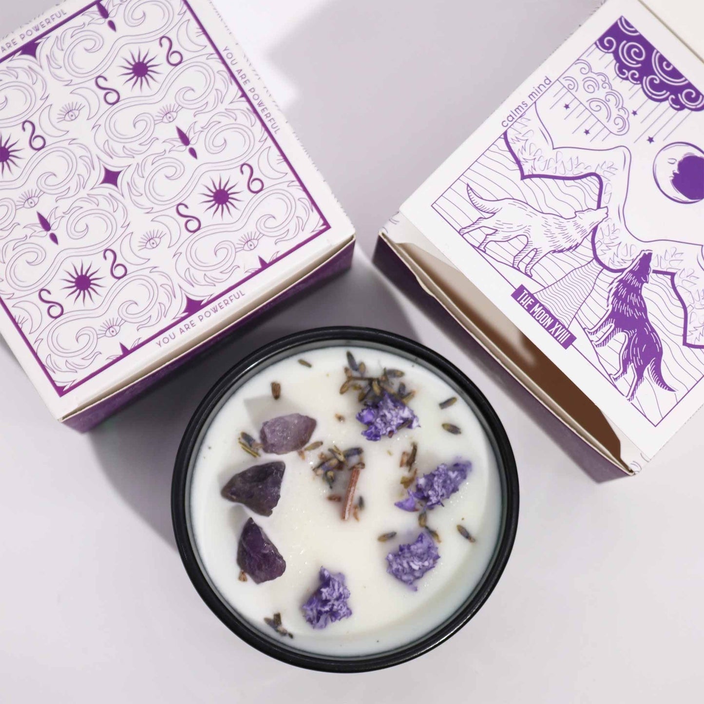 Alt Tag: Lavender Amethyst Crystal Candle – The Moon with lavender botanicals and amethyst stones in tin, shown with moon-themed packaging