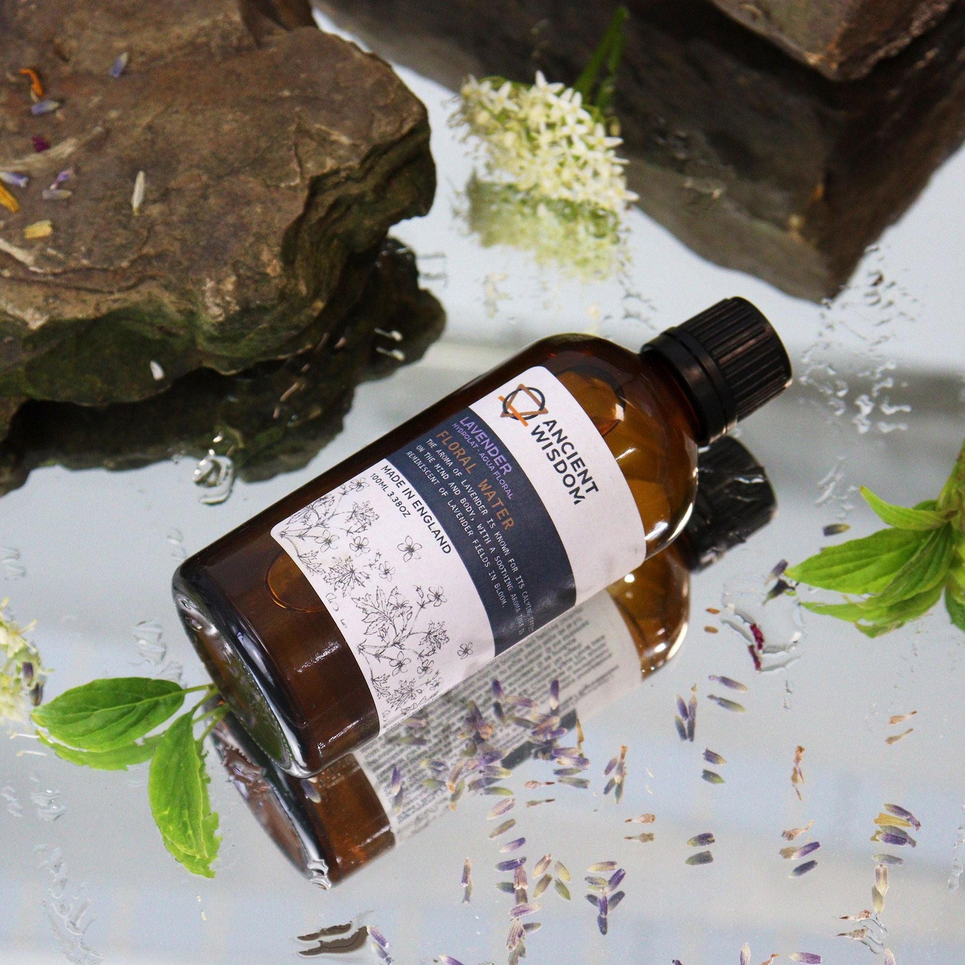 Alt Tag: Lavender Hydrolat – 100 ML Floral Elixir floral water spray bottle with lavender and herbs on reflective surface