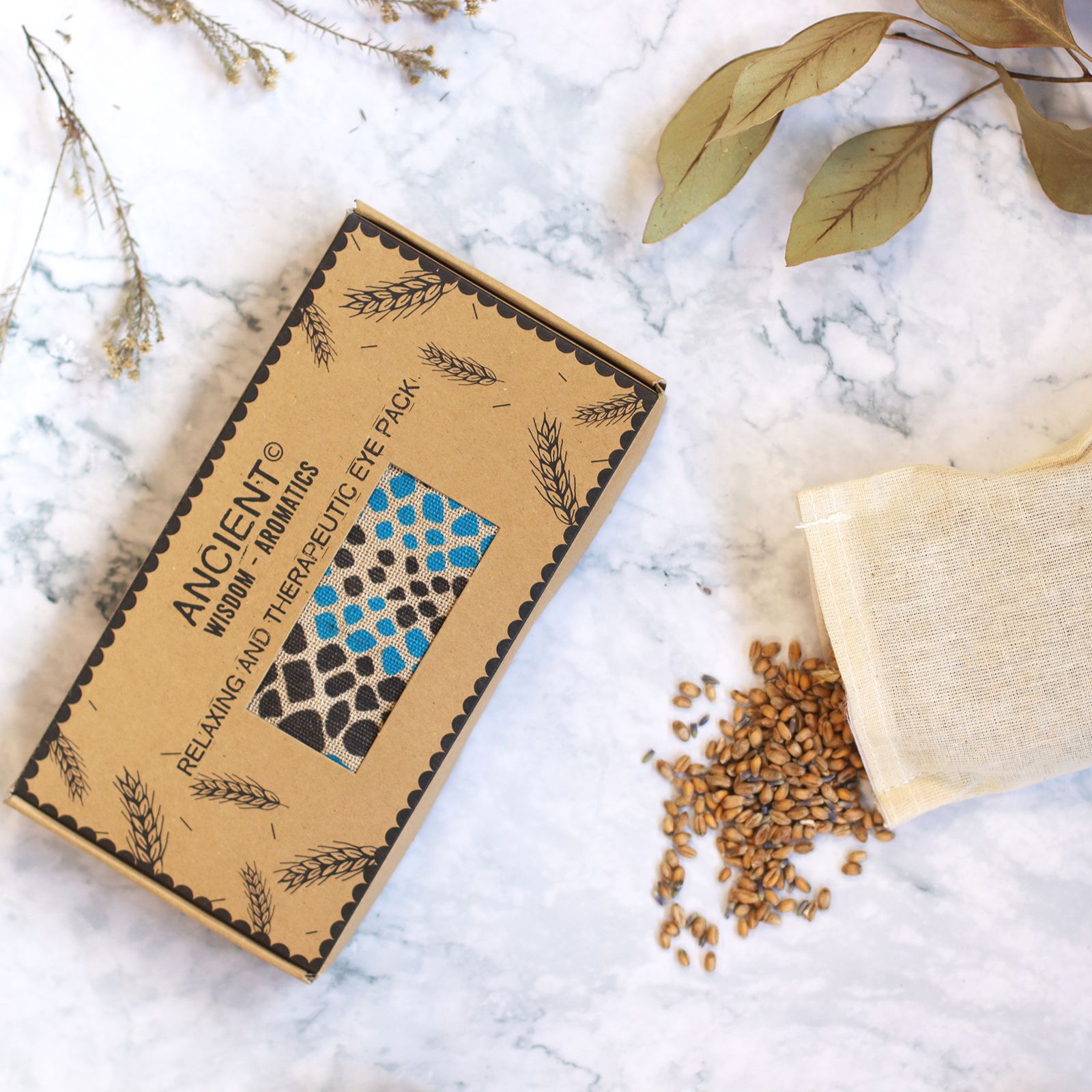 Alt Tag: Lavender Natural Cotton & Juco Eye Pillow in Gift Box – Blue Viper boxed eye pillow with blue viper pattern on marble surface