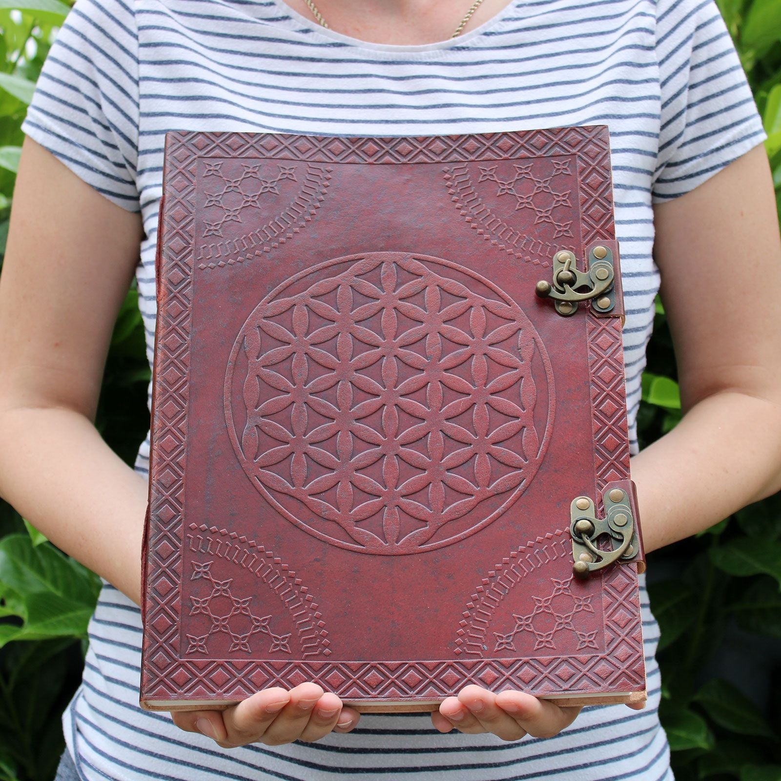 Leather Flower of Life Journal – 200 Pages, 25x32.5 CM leather cover with embossed Flower of Life design and metal clasps, held in hands