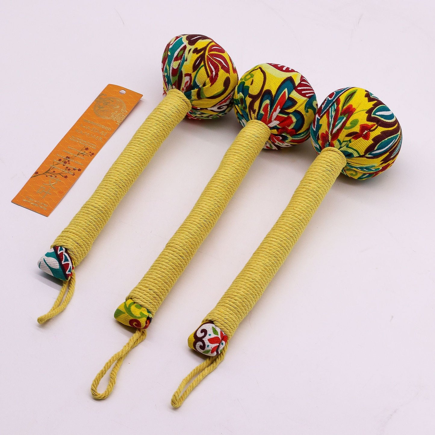 Alt Tag: Lemon Wormwood Massage Hammer – Wooden Tool, set of three handheld wooden tapping hammers with colorful fabric heads and rope handles