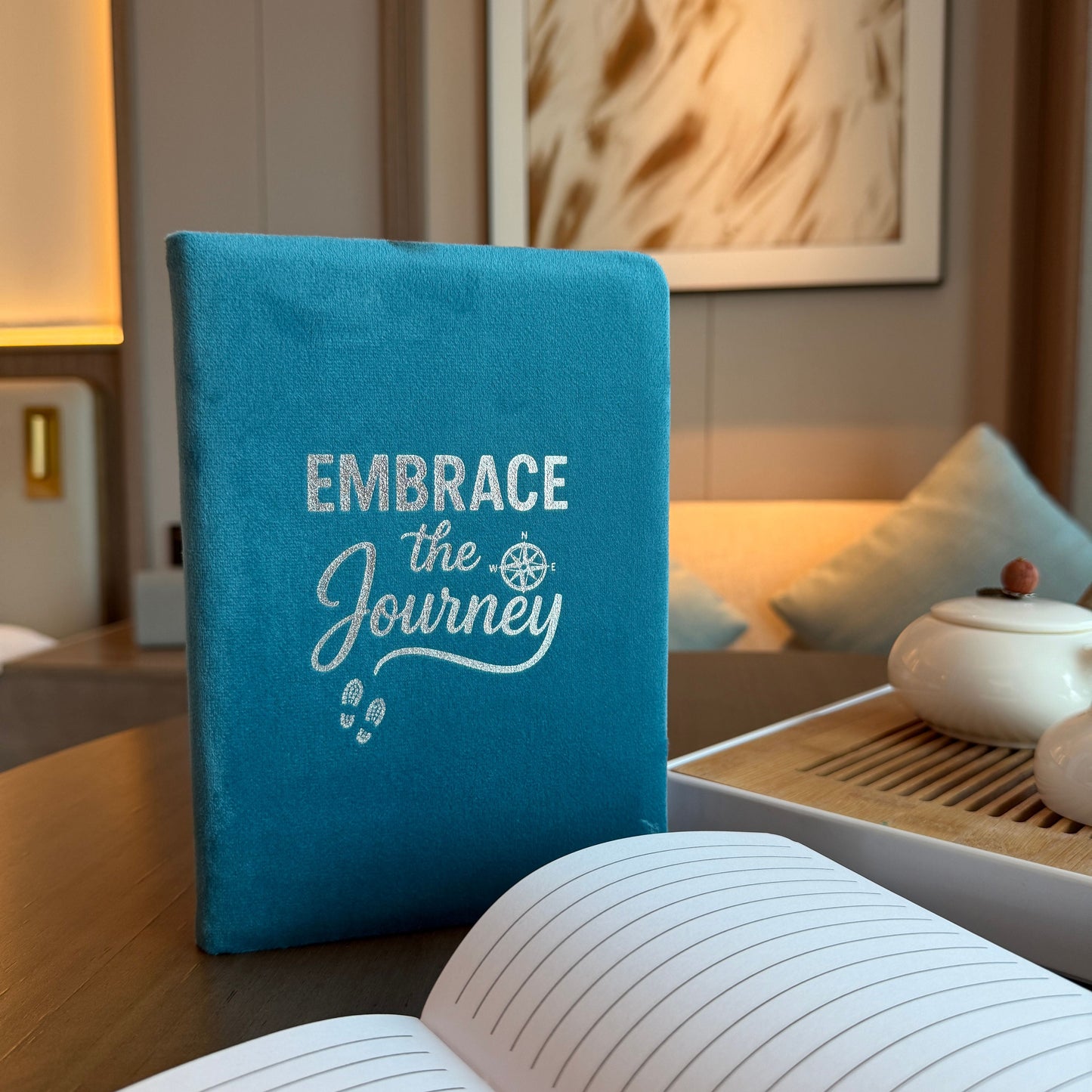 Velvet Wellness Notebook – 80 Pages, light blue velvet cover with “Embrace the Journey” text, lined pages on desk
