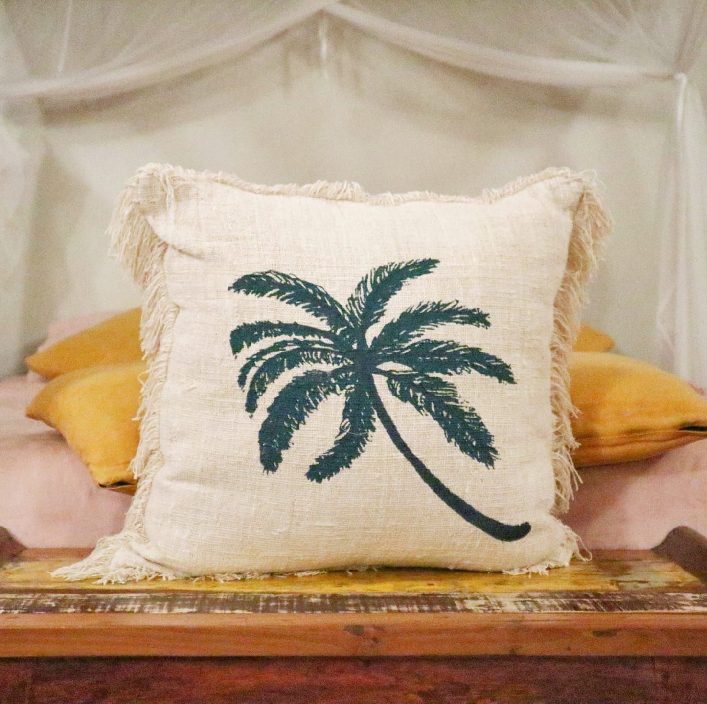 Alt Tag: Linen & Cotton Cushion – 60x60 CM Palm Tree Fringe cushion with palm tree print and fringe trim, styled on bed