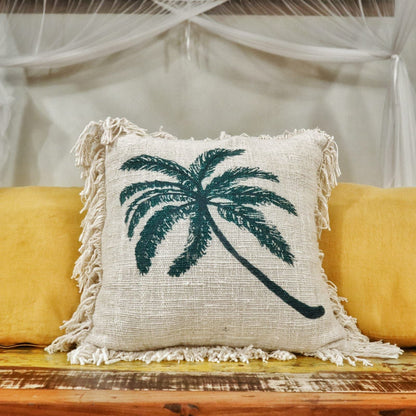 Alt Tag: Linen Palm Tree Cushion – 45x45 CM square linen-cotton cushion cover with palm tree print and fringed edges on sofa